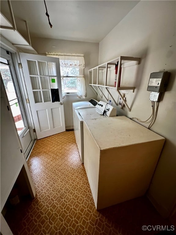 laundry area with separate washer and dryer and a healthy amount of sunlight