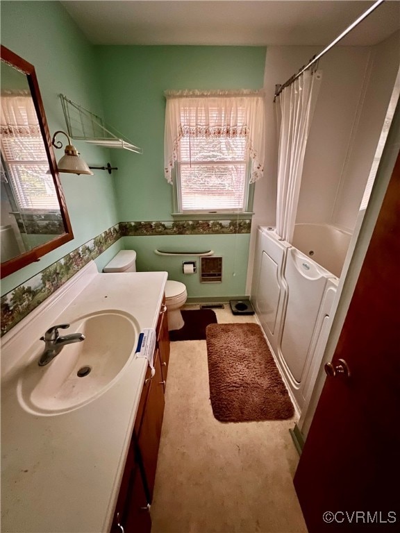 full bathroom featuring toilet, vanity, and shower / tub combo with curtain