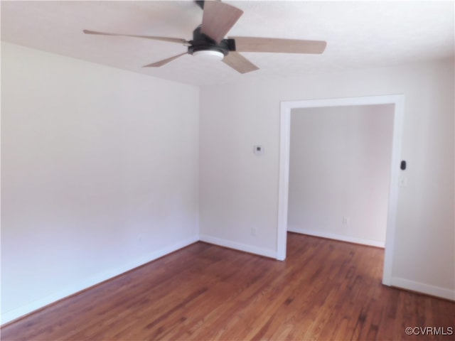 unfurnished room featuring ceiling fan and dark hardwood / wood-style flooring