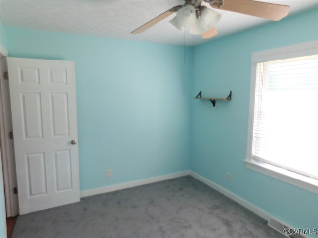 unfurnished room featuring carpet floors and ceiling fan