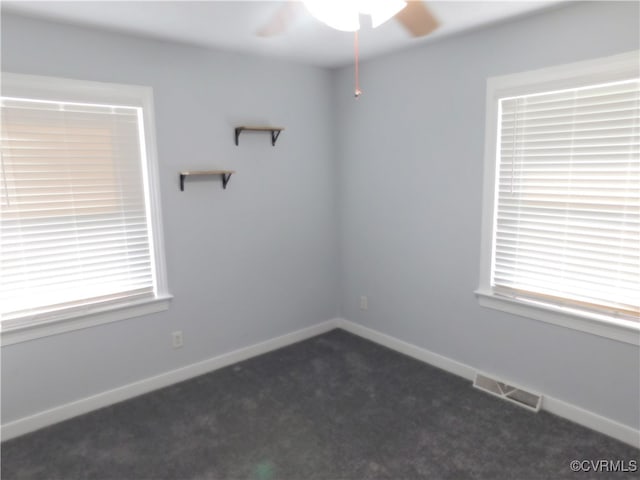 carpeted spare room with ceiling fan