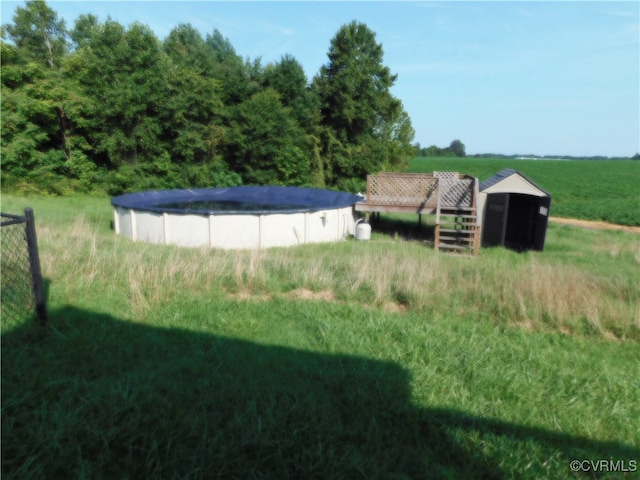 view of yard with a rural view and a covered pool