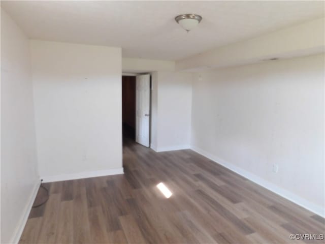 unfurnished room with dark hardwood / wood-style floors