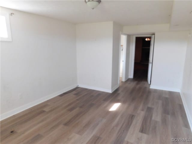 empty room with dark hardwood / wood-style flooring