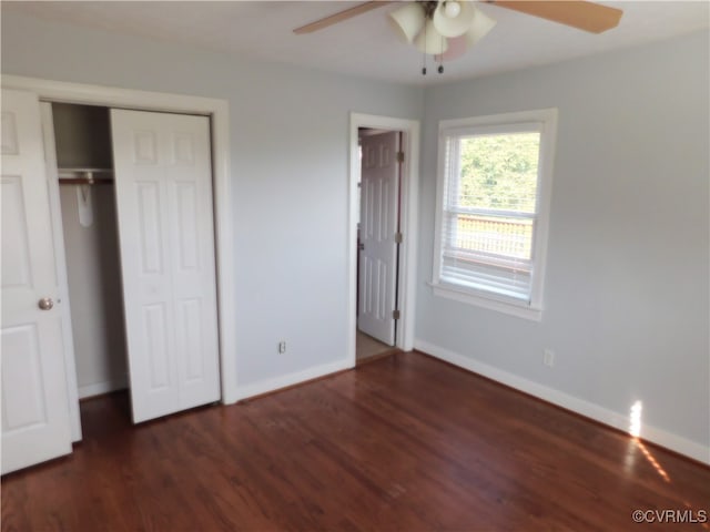 unfurnished bedroom with dark hardwood / wood-style flooring, a closet, and ceiling fan