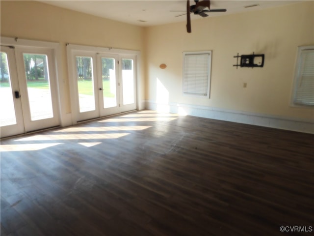 unfurnished living room featuring ceiling fan, dark hardwood / wood-style flooring, and french doors