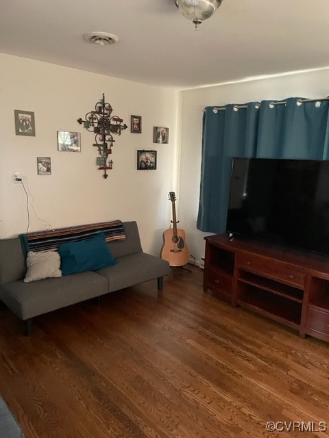 living room featuring dark wood-type flooring