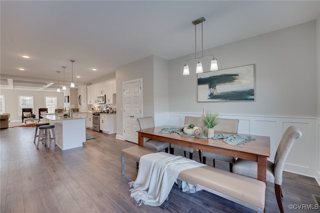 dining room featuring beamed ceiling and wood-type flooring