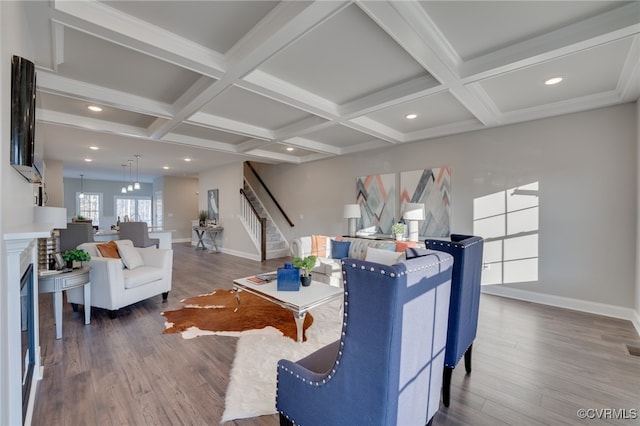 living room with beamed ceiling, wood-type flooring, and coffered ceiling