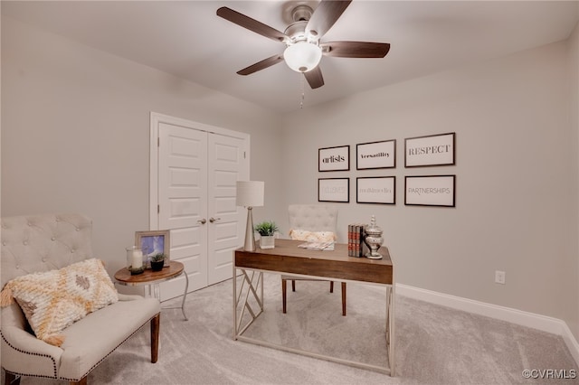 carpeted office space with ceiling fan