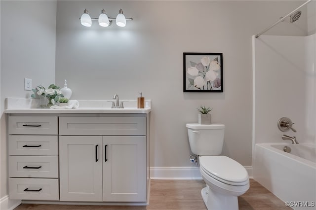 full bathroom featuring hardwood / wood-style flooring, vanity, toilet, and shower / bathing tub combination