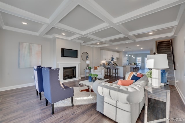 living room featuring beamed ceiling, coffered ceiling, and hardwood / wood-style flooring