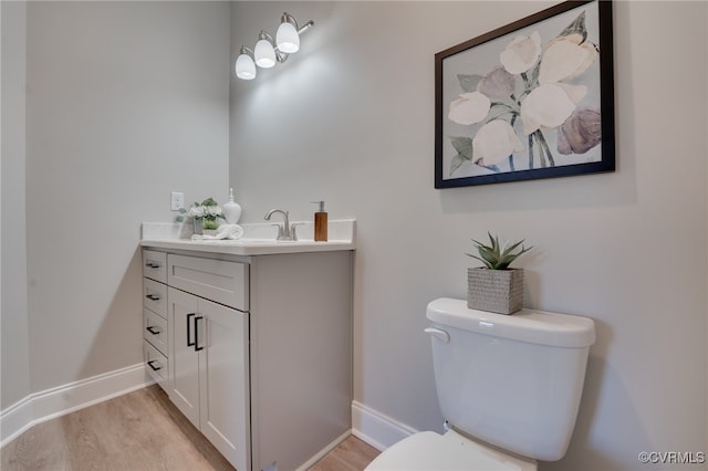 bathroom featuring hardwood / wood-style floors, vanity, and toilet