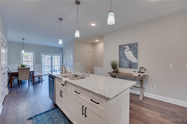 kitchen featuring white cabinets, an island with sink, stainless steel dishwasher, and dark hardwood / wood-style floors