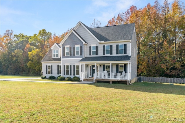 colonial-style house with central AC, a porch, and a front yard