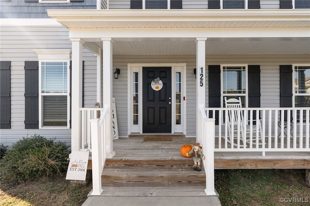 view of exterior entry featuring a porch