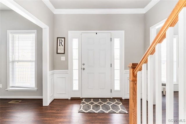 foyer entrance featuring dark hardwood / wood-style floors and ornamental molding