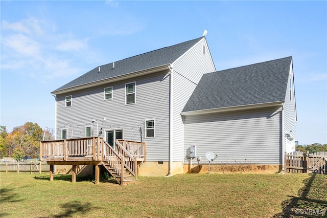 back of house with a deck and a lawn