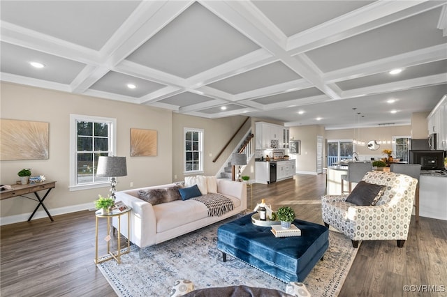 living room featuring beamed ceiling, dark hardwood / wood-style flooring, crown molding, and coffered ceiling