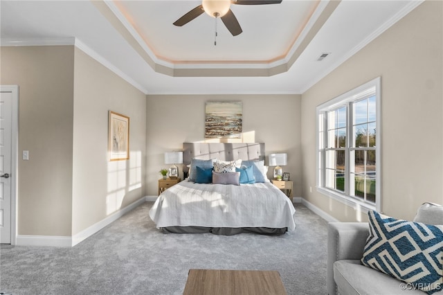 bedroom with a raised ceiling, ceiling fan, crown molding, and carpet