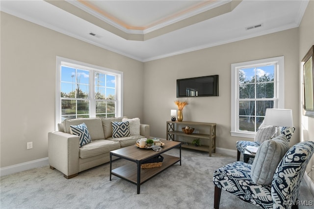 living room with light carpet, ornamental molding, and a healthy amount of sunlight