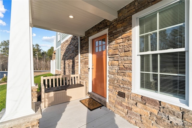 view of exterior entry with covered porch