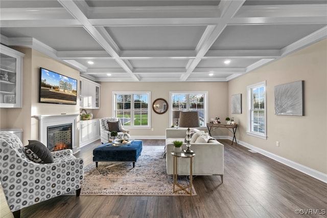 living room with beam ceiling, dark hardwood / wood-style flooring, coffered ceiling, and ornamental molding