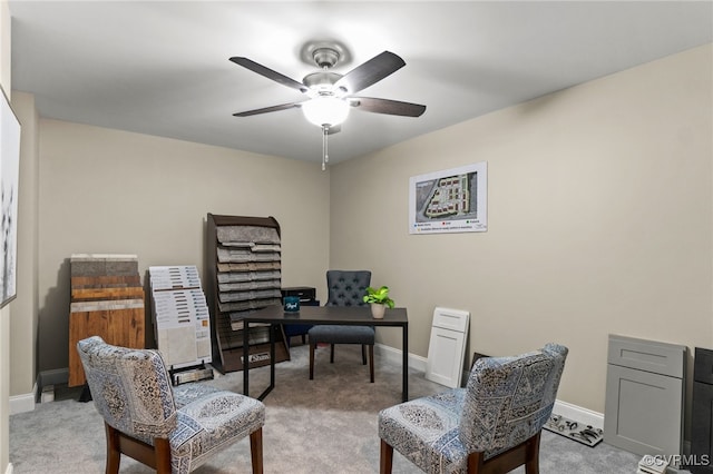 office space featuring light carpet and ceiling fan