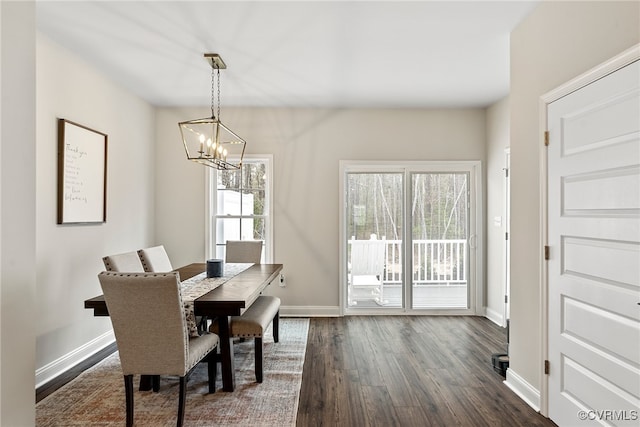 dining space featuring a chandelier and dark hardwood / wood-style floors