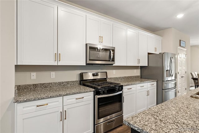 6412 Sanford Springs Cv, Midlothian, VA 23112 - kitchen with appliances with stainless steel finishes, white cabinetry, light stone countertops, recessed lighting, and dark wood-type flooring