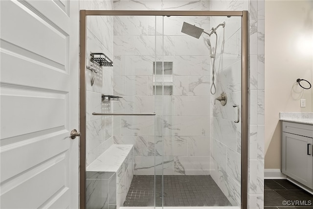 bathroom with tile patterned floors, vanity, and an enclosed shower