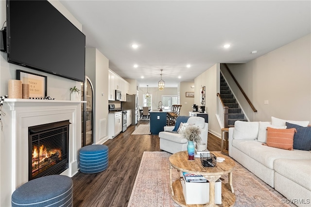 living room featuring dark hardwood / wood-style floors and sink