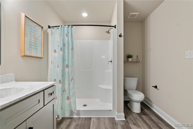 bathroom with a shower with shower curtain, vanity, toilet, and wood-type flooring