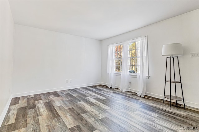 spare room with wood-type flooring