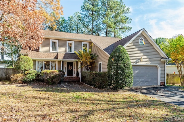 view of property with a garage and a front yard