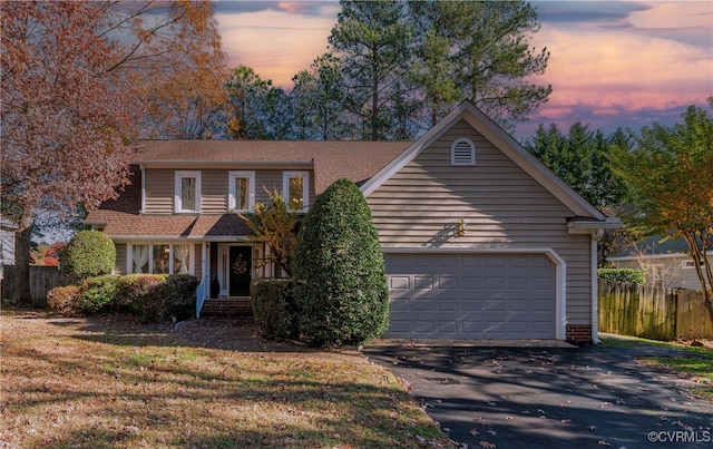 view of front facade with a garage and a lawn