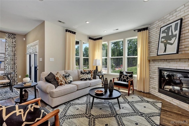 living room with hardwood / wood-style flooring and a fireplace