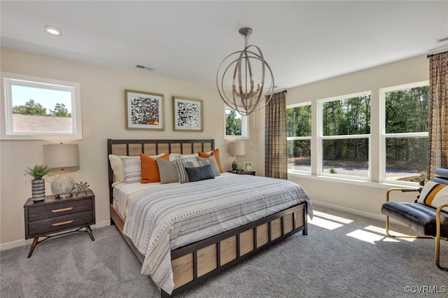 bedroom with light colored carpet and a notable chandelier