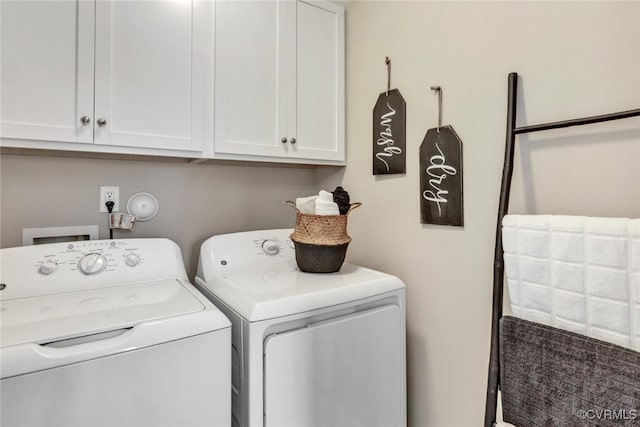 laundry room featuring cabinets and washer and dryer