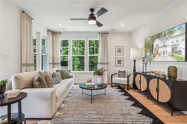 living area with recessed lighting, wood finished floors, and a ceiling fan