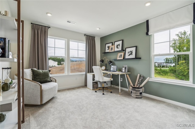 carpeted office space featuring recessed lighting, baseboards, and visible vents