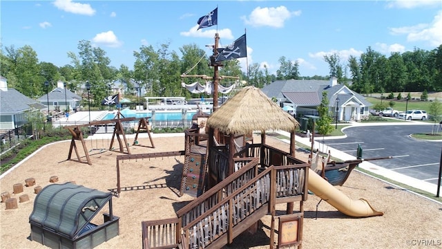 community playground with a community pool and fence