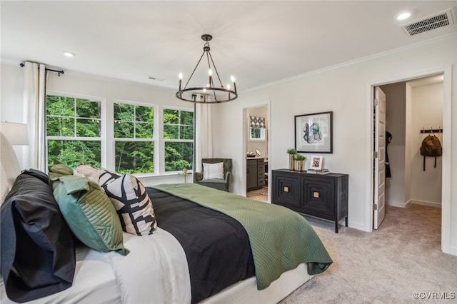 carpeted bedroom with crown molding, a chandelier, and ensuite bathroom