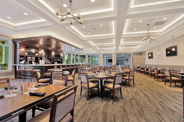 dining space with crown molding, plenty of natural light, coffered ceiling, and a chandelier