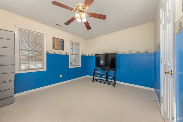 interior space featuring ceiling fan, a healthy amount of sunlight, and light colored carpet