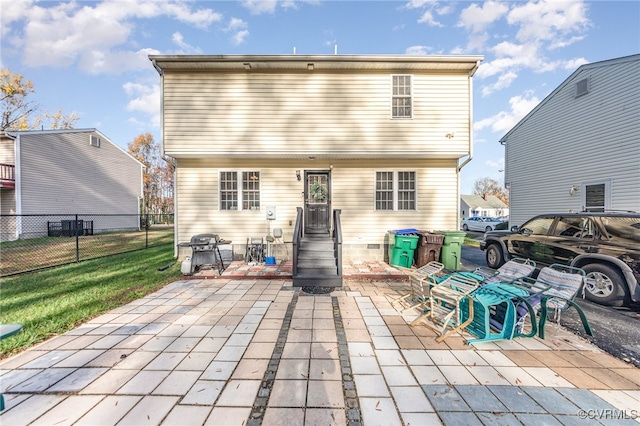 back of house featuring a yard and a patio