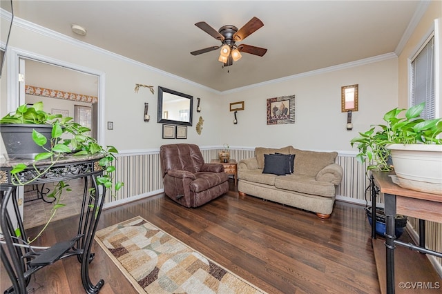 living room featuring dark hardwood / wood-style floors, ceiling fan, and crown molding