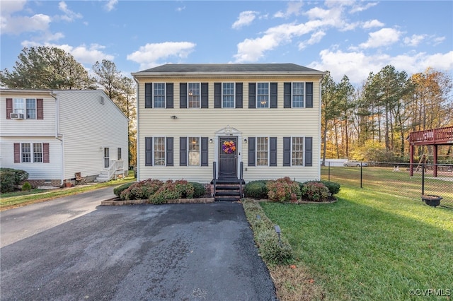 colonial-style house with a front yard