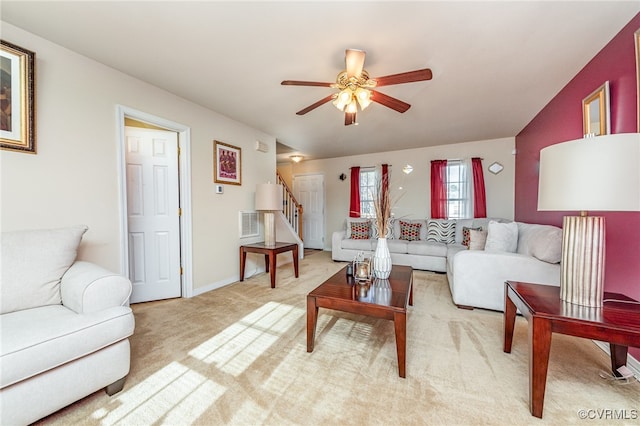 carpeted living room with ceiling fan