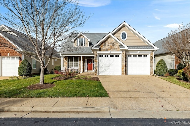 view of front of house featuring a porch, a front yard, and a garage